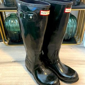 Tall black glossy hunter boots